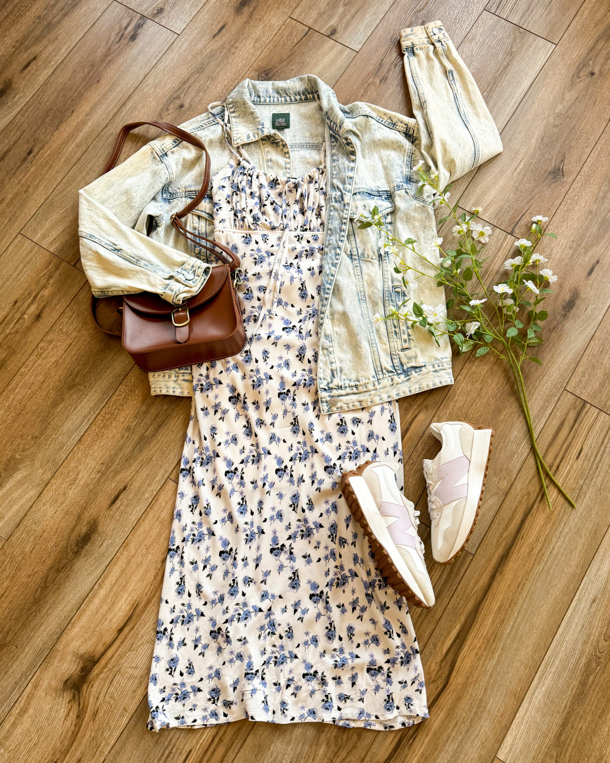 a floral midi dress styled with new balance sneakers and an oversized denim jacket. Everyday Spring Trends