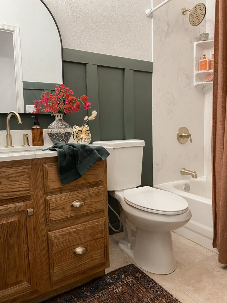 Small Bathroom Makeover. 90s builder grade bathroom remodel. honey oak cabinet makeover. how to update honey oak cabinets. how to update 90s oak cabinets. benjamin moore backwoods. moody green small bathroom. moody green bathroom walls wood cabinets