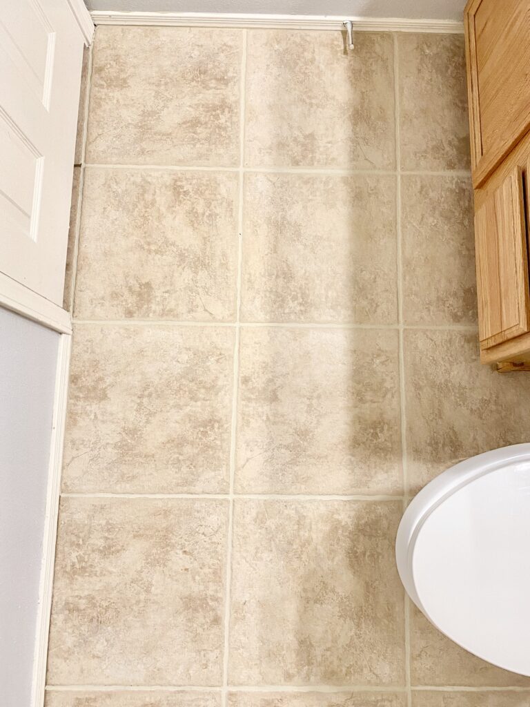 Small Bathroom Makeover. tile grout paint. updating tile grout lines. updating tile grout. grout seal and paint. how to lighten grout.