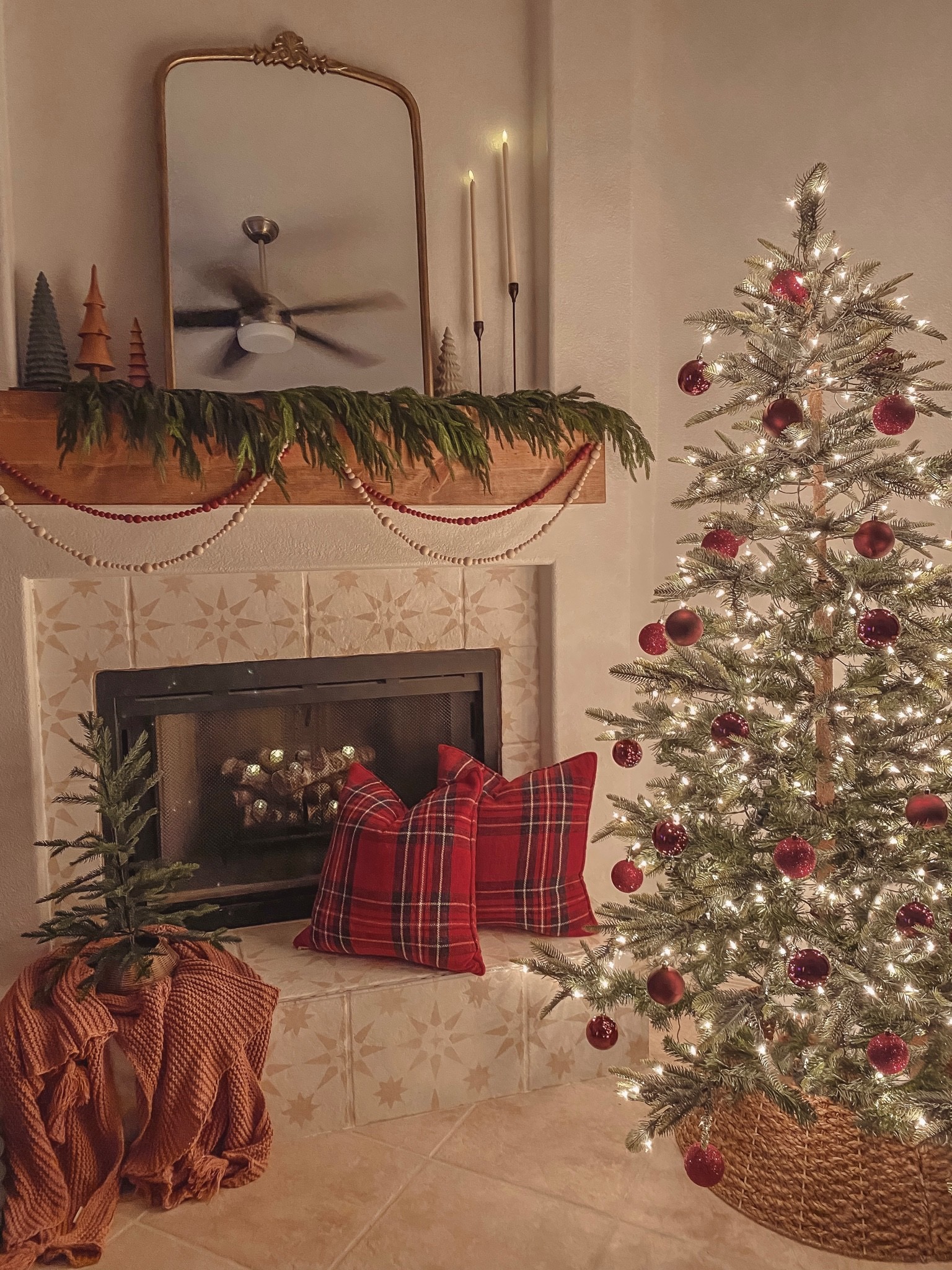 norfolk pine garland. norfolk garland. warm christmas decor. christmas fireplace decor ideas. norfolk christmas garland. afloral real touch norfolk christmas garland. sparse christmas tree decor.