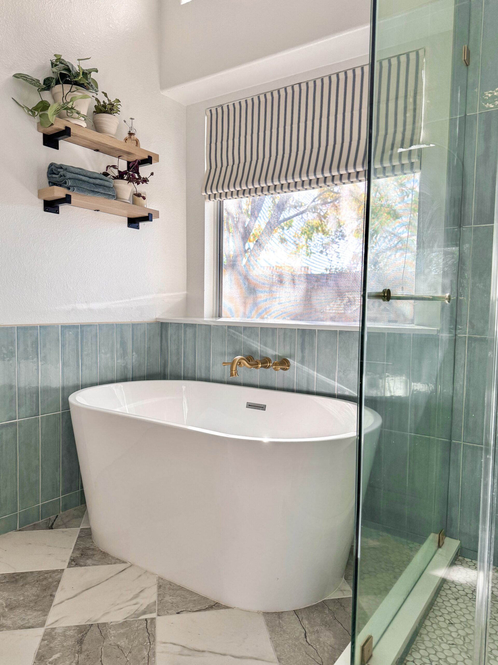 standing tub wall shelf. soaker tub ideas. checkerboard bathroom floor ideas. checkerboard tile. bathroom shelves. bathtub shelf ideas. bathroom plant shelf.