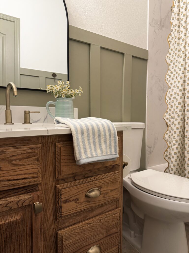 svelte sage sherwin williams. olive green bathroom. golden green paint color. yellow green paint color. honey oak cabinets ideas. 90s bathroom makeover. builder grade bathroom ideas.