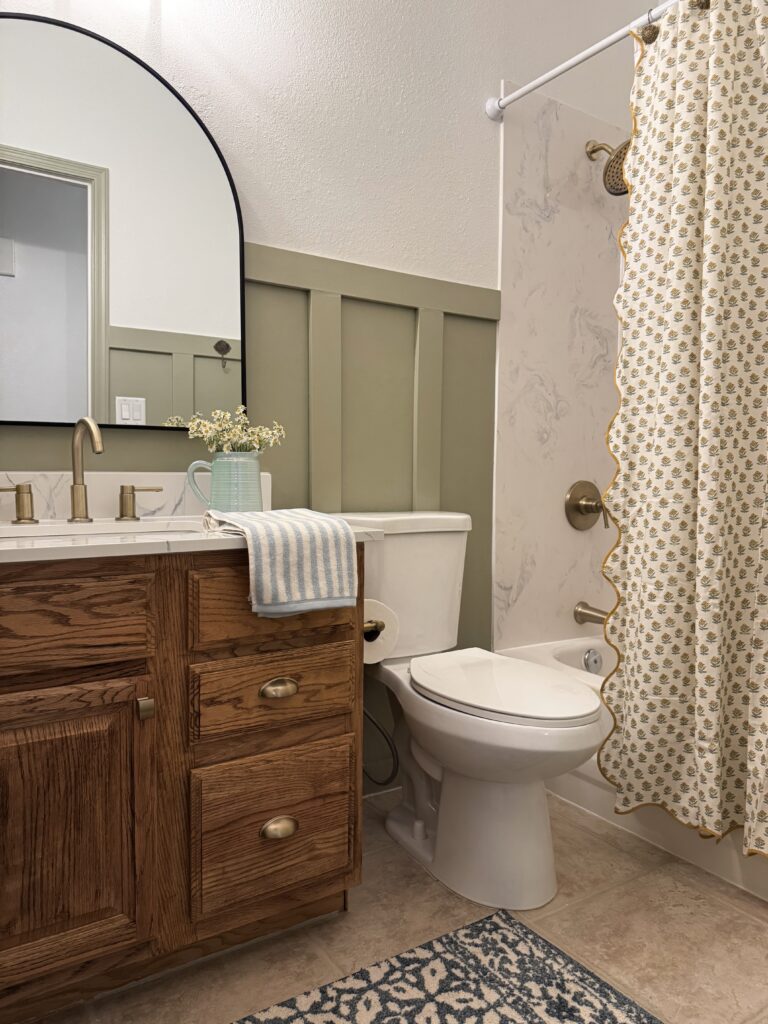 svelte sage sherwin williams. olive green bathroom. golden green paint color. yellow green paint color. honey oak cabinets ideas. 90s bathroom makeover. builder grade bathroom ideas.